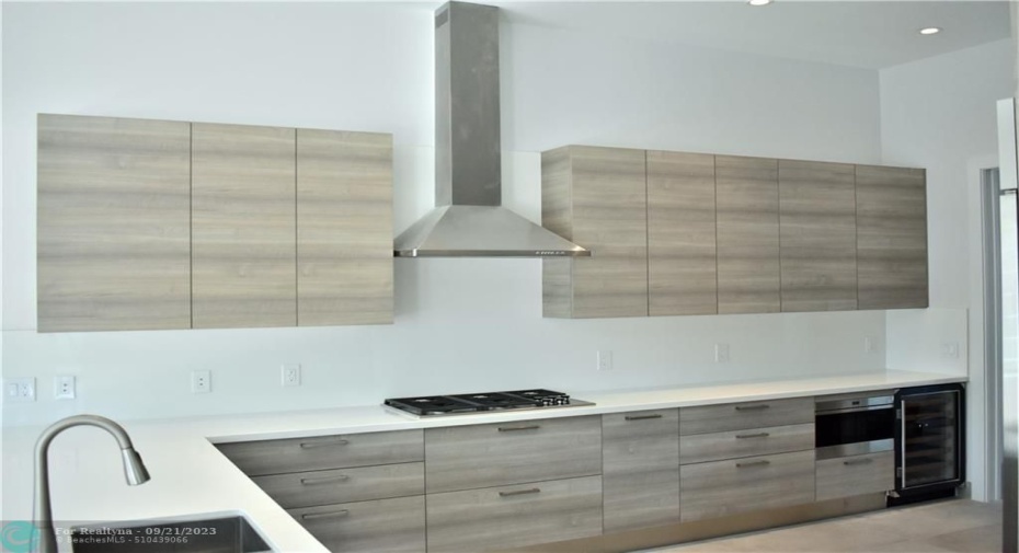 Photo from previously built Deerwood Model Home. Imported Italian cabinetry, natural gas cooktop, quartz countertops