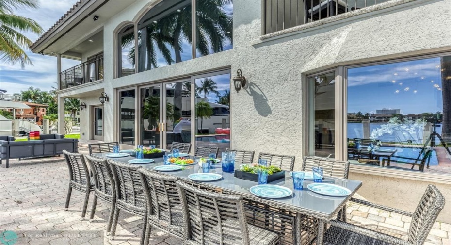 Outdoor waterfront Point Lot with pool area with outdoor dining, lounge chairs, BBQ & siting area.