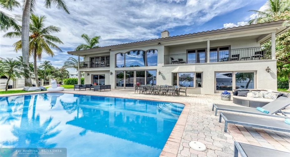 Outdoor waterfront Point Lot with pool area with outdoor dining, lounge chairs, BBQ & siting area.