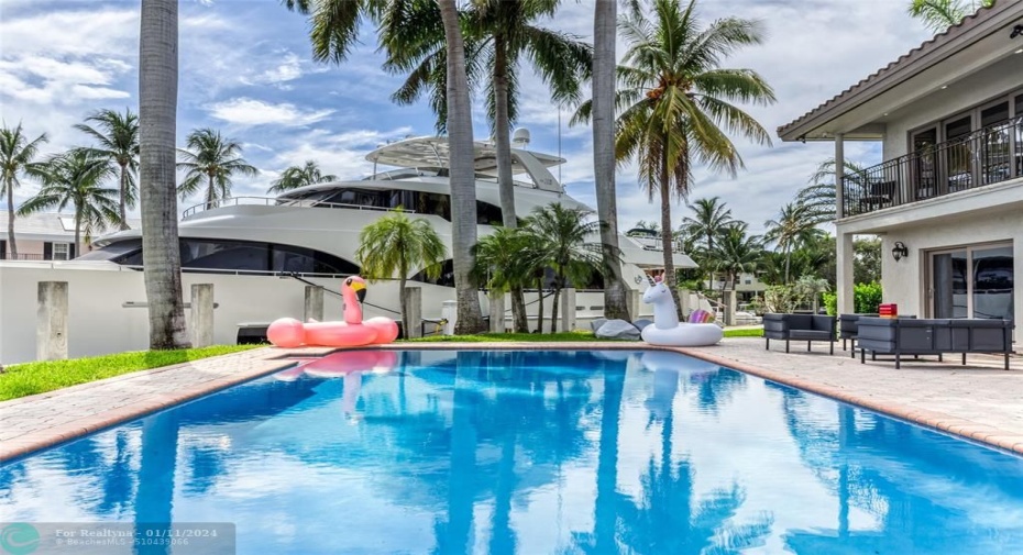 Outdoor waterfront Point Lot with pool area with outdoor dining, lounge chairs, BBQ & siting area.