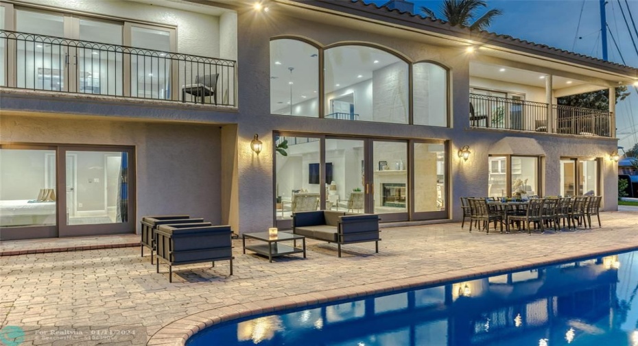 Outdoor waterfront Point Lot with pool area with outdoor dining, lounge chairs, BBQ & siting area.