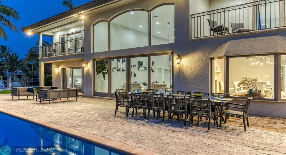 Outdoor waterfront Point Lot with pool area with outdoor dining, lounge chairs, BBQ & siting area.