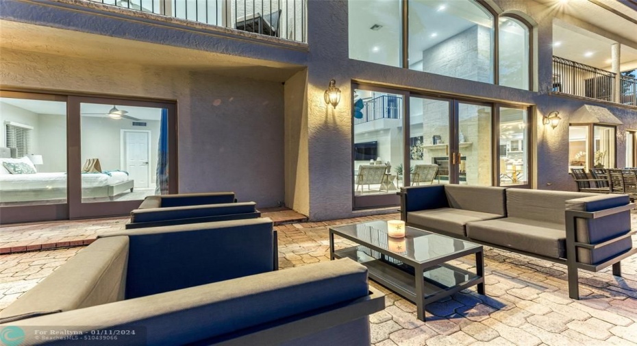 Outdoor waterfront Point Lot with pool area with outdoor dining, lounge chairs, BBQ & siting area.