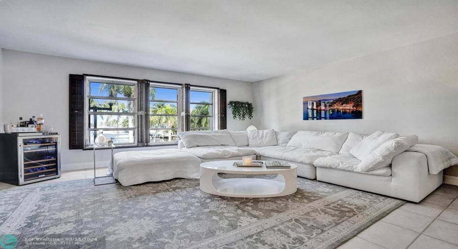 LIVING ROOM WITH GRAND WATER VIEWS.
