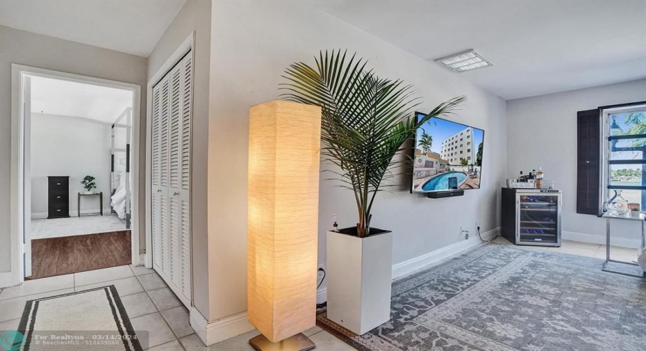 SMALL HALLWAY LEADS TO LARGE BEDROOM.