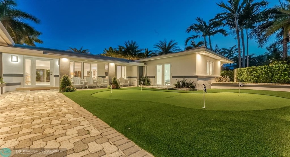 Gated entry to home with putting green.