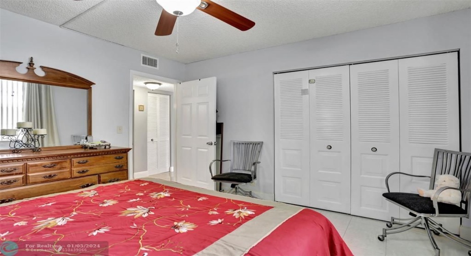 GUEST BEDROOM: TILE FLOORING; CEILING FAN REPLACED; RAISED PANEL DOOR.
