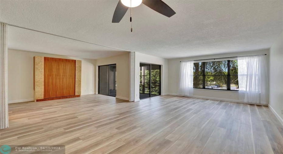 From the Dining Area you are looking at the 2nd Bedroom/Den (Convertible), Living Room & HUGE SCREENED-IN BALCONY that's 16' WIDE & is ACCESSIBLE from Living Room, Primary & 2nd Bedrooms! WOW! YOU WILL LOVE WHERE YOU LIVE & PLAY!