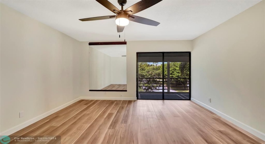 This is YOUR FUTURE PRIMARY BEDROOM! WOW! Includes CUSTOM MIRROR & 1 of 3 NEW LED LIGHT CEILING FANS! The Primary Bedroom also has Access to the HUGE SCREENED-IN BALCONY that's 16' WIDE.