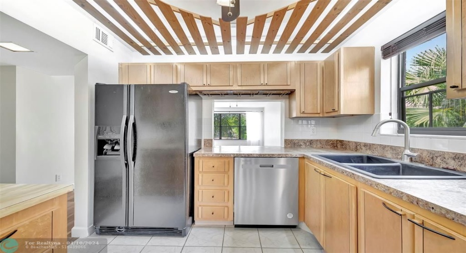 YOUR FUTURE Kitchen has CUSTOM CABINETS (EXOTIC BURL VANEER), CUSTOM WOOD SLATTED CEILING, NEW DISHWASHER, Lots of Cabinet and Counter Space, a Pass-thru window to the Dining Area, and even comes complete with MOTION SENSOR UNDER CABINET LIGHTING & UNDER CABINET CAN OPENER. SIDE-BY-SIDE REFRIGERATOR WITH WATER & ICE DISPENSER & MORE!
