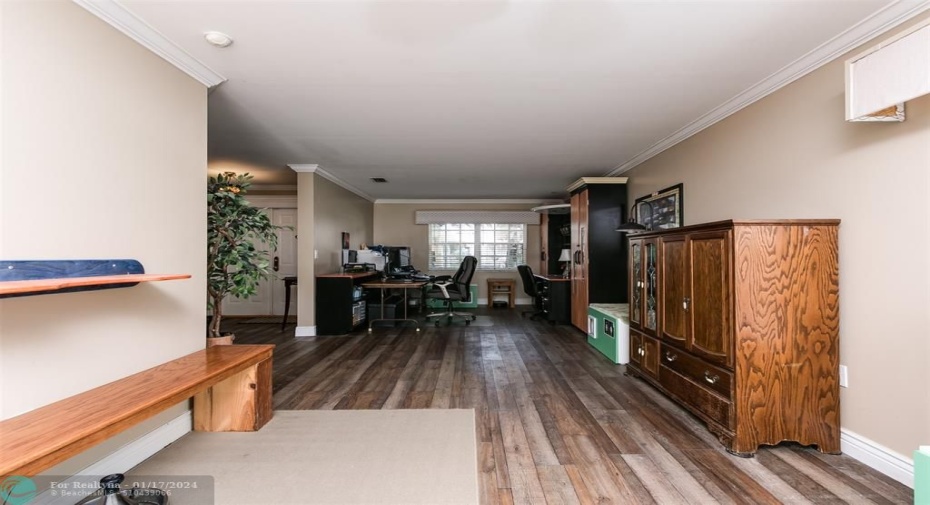 Long view of formal dining room and living room.