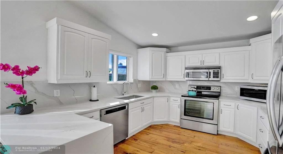 Custom maple cabinets, quartz countertops & stainless-steel appliances