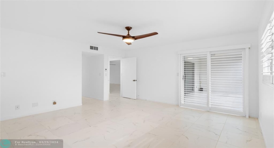 Primary Bedroom - beautiful plantation shutters and fan overhead