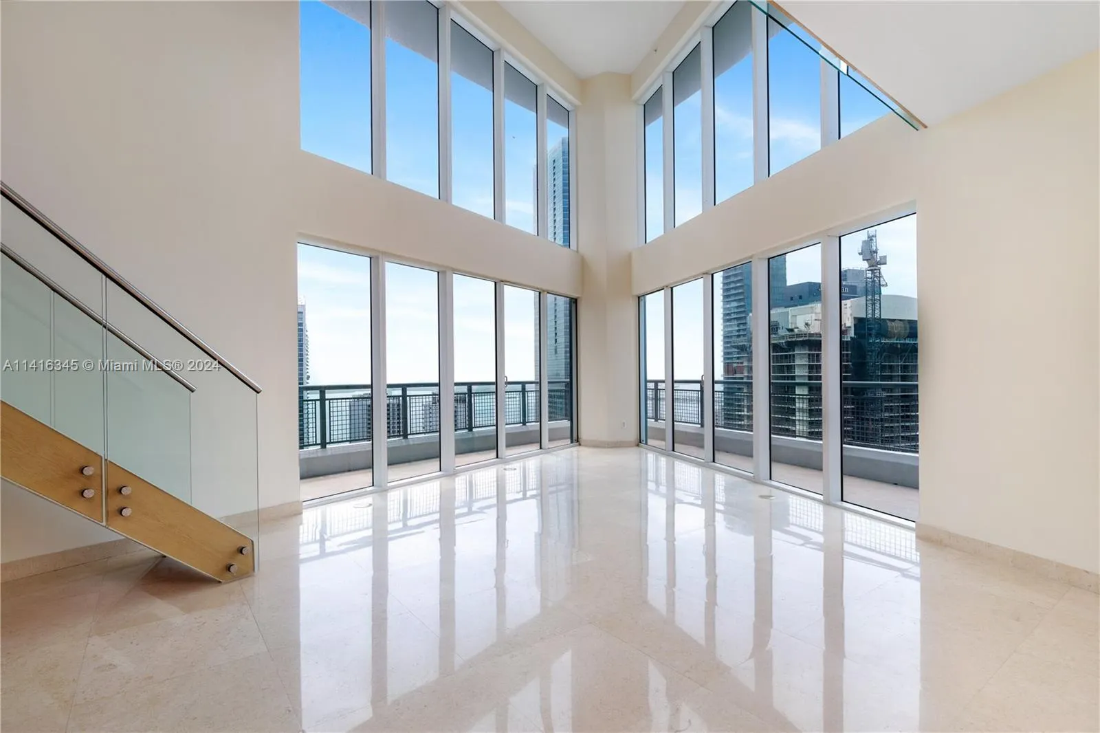 Social area offers breathtaking views over Biscayne Bay and Brickell Avenue from inside and from the large wraparound balcony