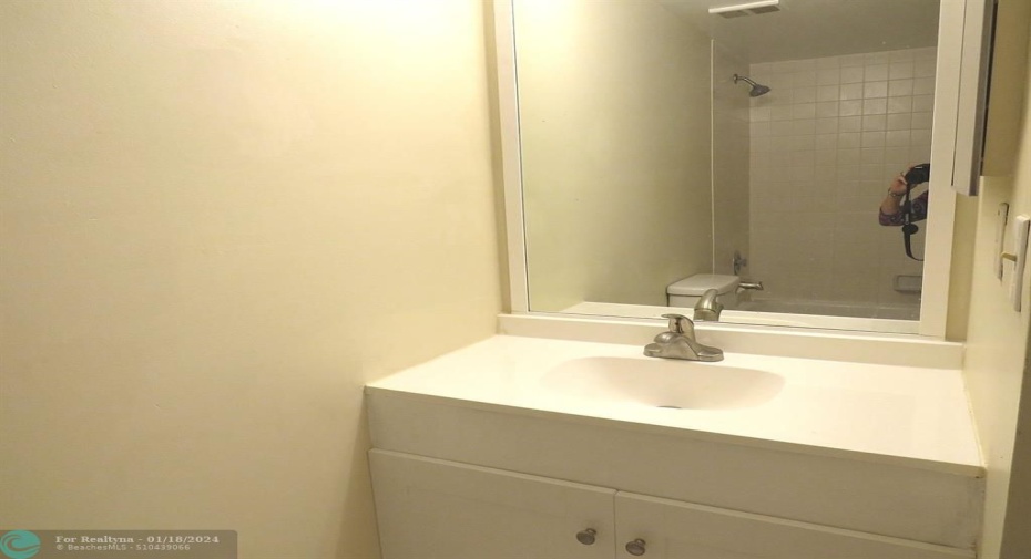 Second bathroom with tub shower.
