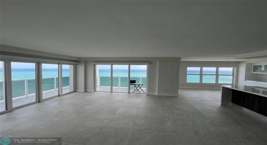 The living room is open allowing direct ocean views from living room, the kitchen and the dining room.