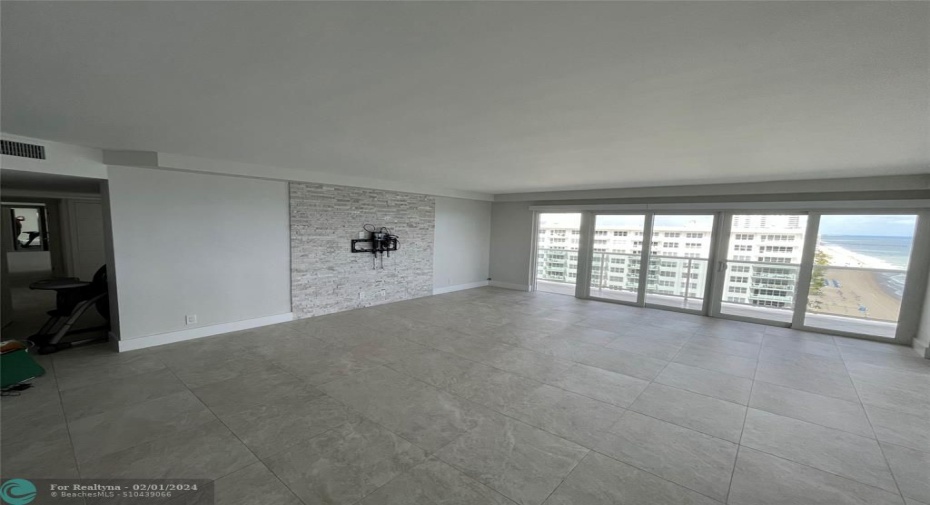 The tiled walled features a wall-mounted TV mount.