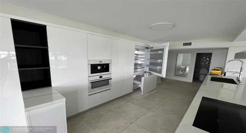 The refrigerator opened to show how they are concealed when closed.
