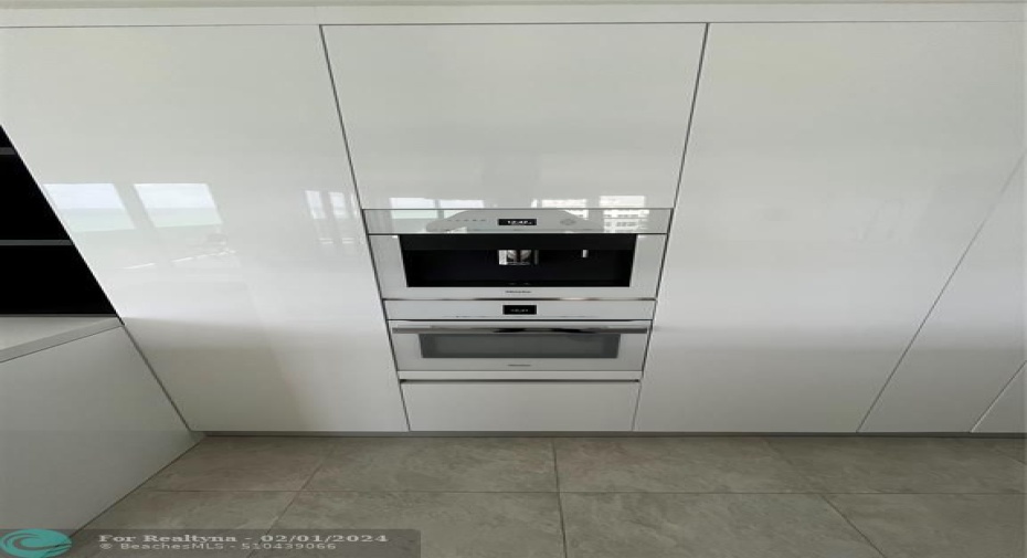 The top-of-the-line kitchen features two built-in Miele® ovens including convection and microwave
