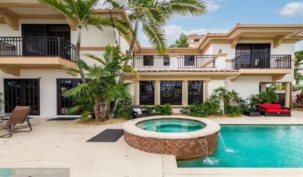 The impressive rear of  the home with 3 balconies