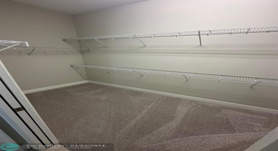 Primary Bedroom Large Walk In Closet with New carpets