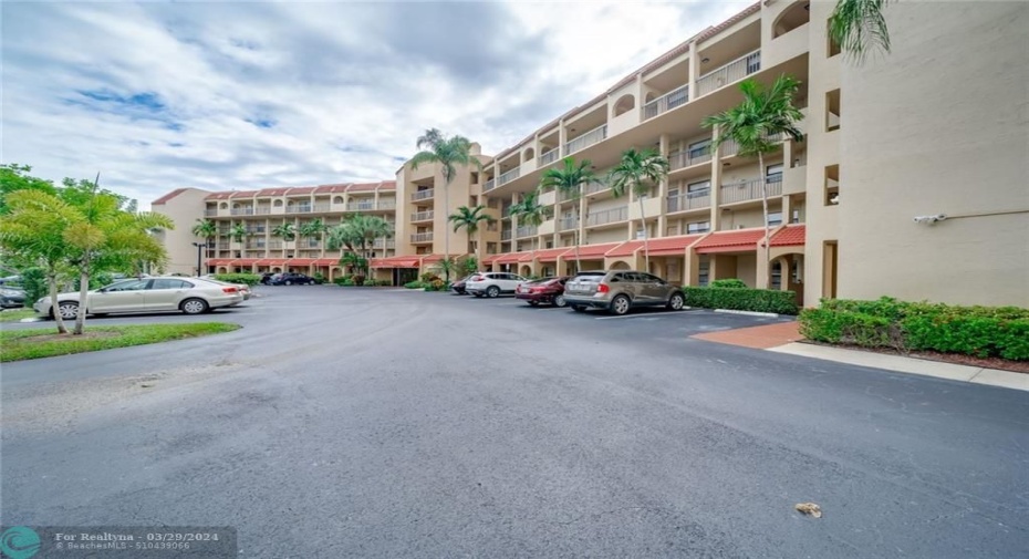 FRONT OF BUILDING WITH SPACIOUS PARKING LOT