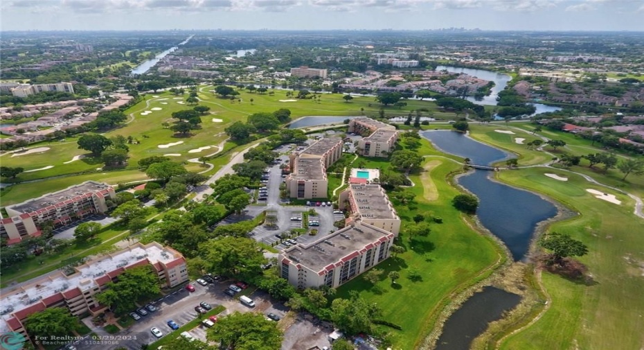 AERIAL VIEW - UNIT IS LOCATED IN MIDDLE BUILDING SURROUNDED BY GREEN SPACE