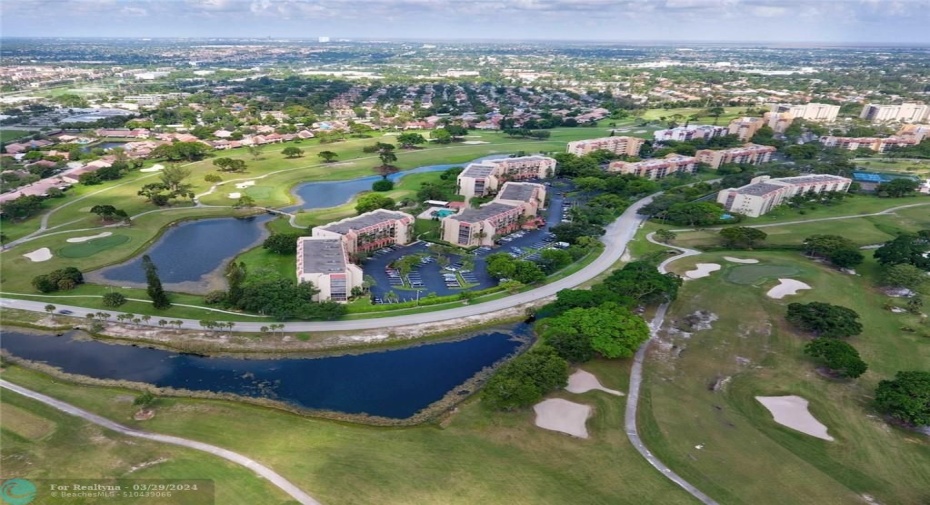 AERIAL VIEW - UNIT IS LOCATED IN MIDDLE  BUILDING SURROUNDED BY GREEN SPACE