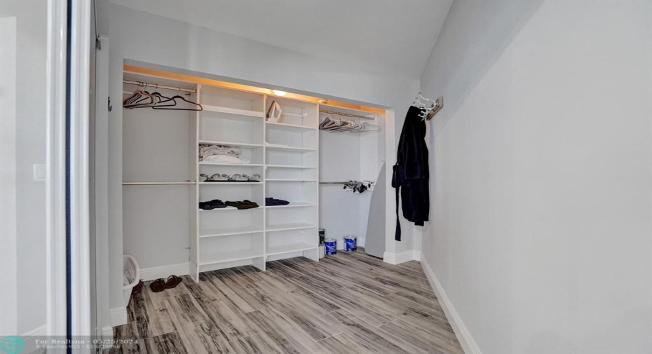 Primary bedroom walk-in closet