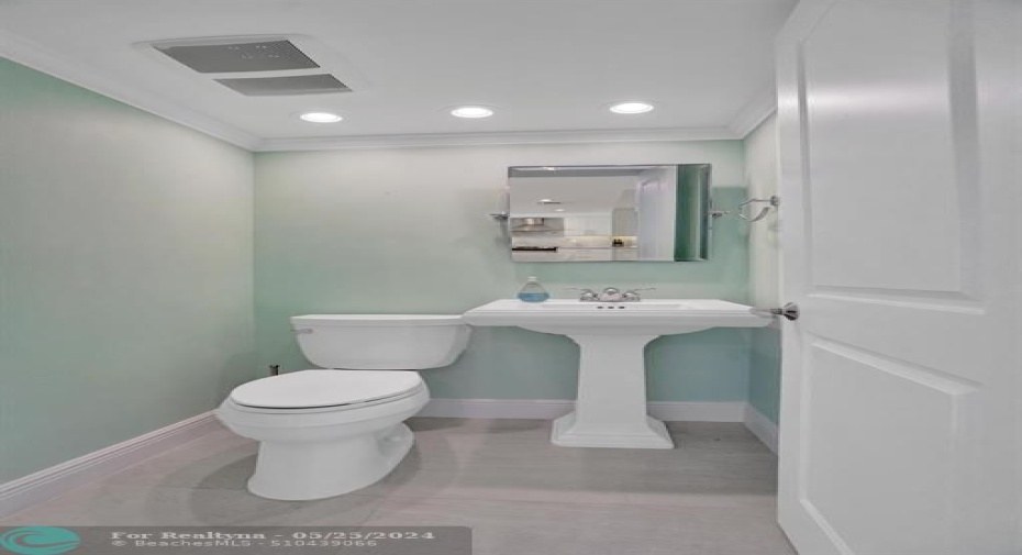 Powder room next to kitchen.