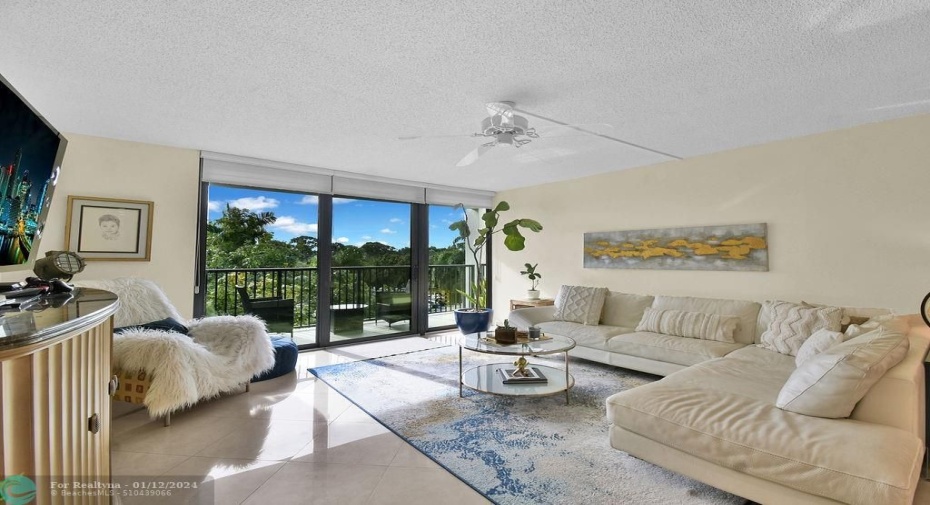 Spacious Living Room with New Impact Glass Windows leading to Balcony