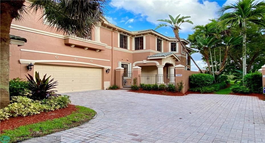 Front of the property with ample driveway and 2 car garage
