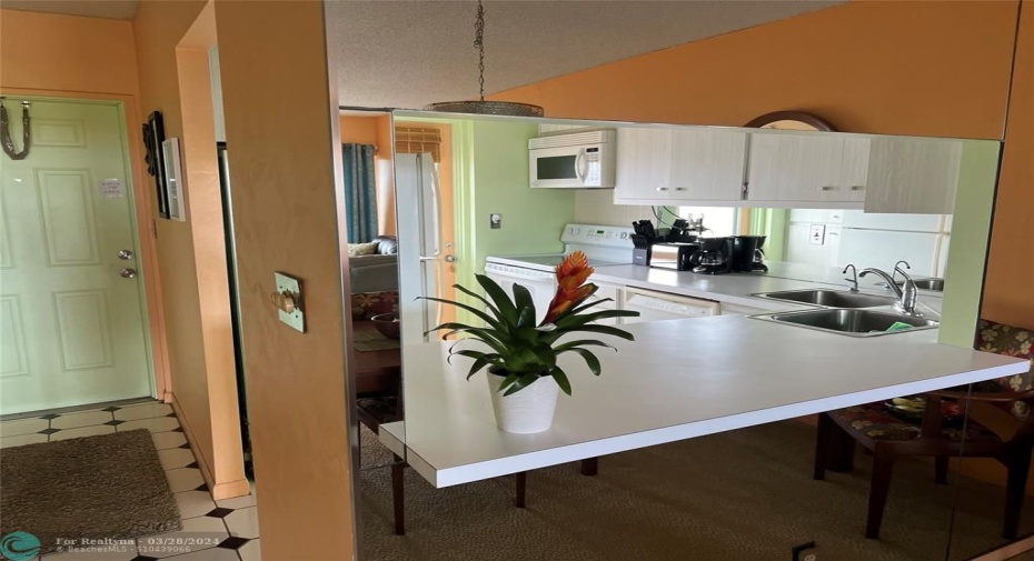 Foyer wall and upper cabinets can be removed and really open up the space.