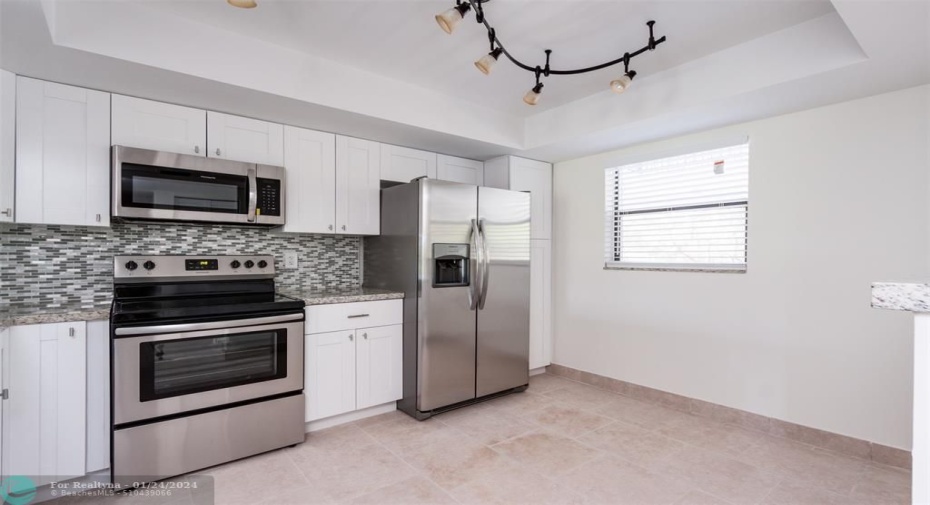 Kitchen - Completely updated with White cabinetry & SS Appliances.