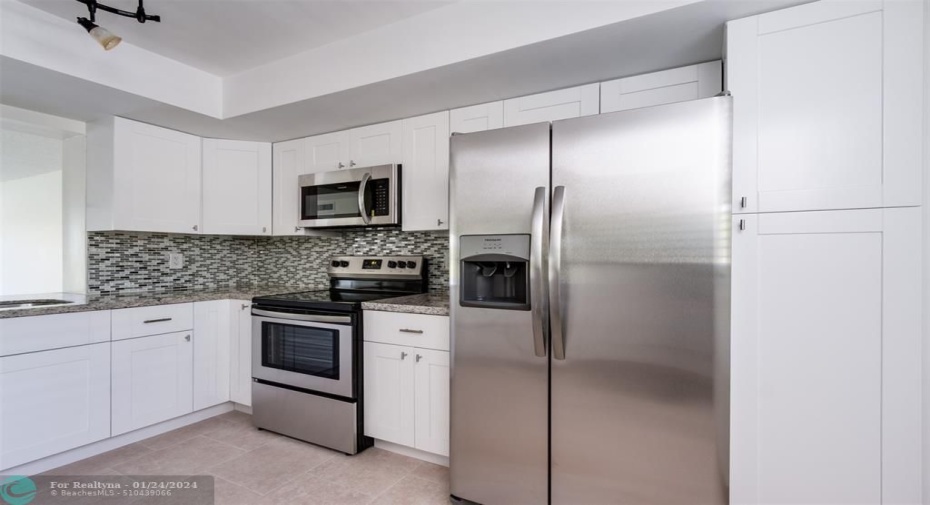 Kitchen has been updated with fine appointments, granite countertops and backsplash