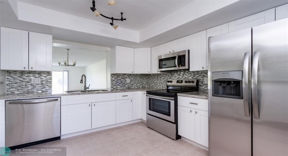 kitchen - Updated Kitchen lighting and wide pass-through access from Kitchen to dining room.