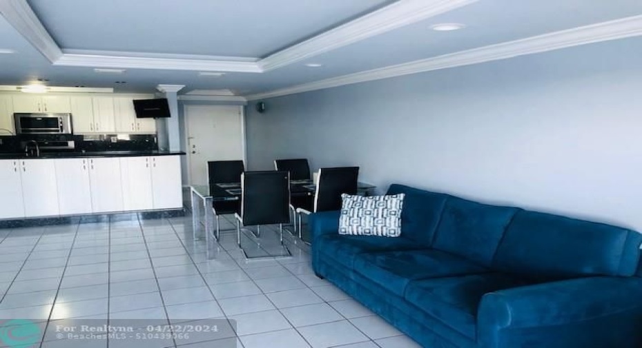 Living room facing kitchen and entrance