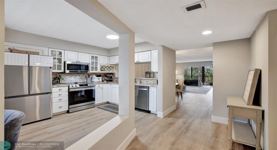 Foyer entrance leading to Kitchen and open floor plan.