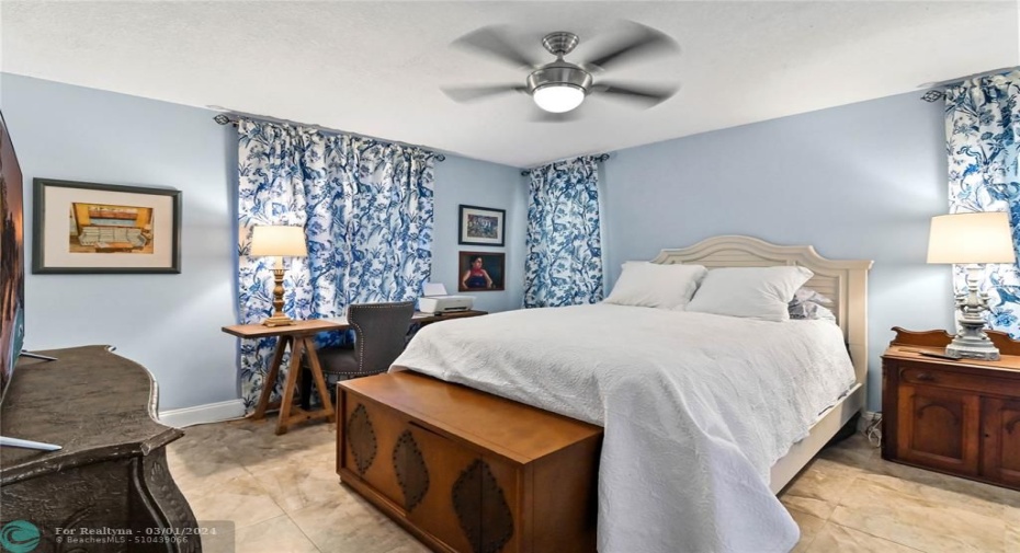 Primary bedroom with designer ceiling fan and walk-in closet
