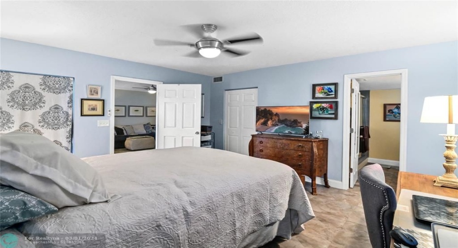 Spacious primary bedroom with sliding glass door to screened patio