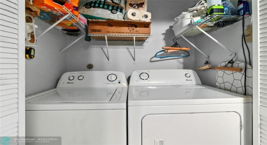 Full size washer dryer located in foyer area
