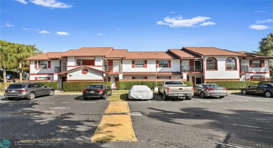 Two story building with parking in front of unit and plenty of guest parking - roof replaced in 2022