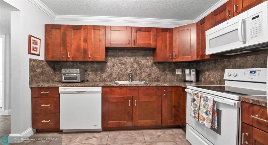 Updated kitchen with wood kitchen cabinets and  crown moldings