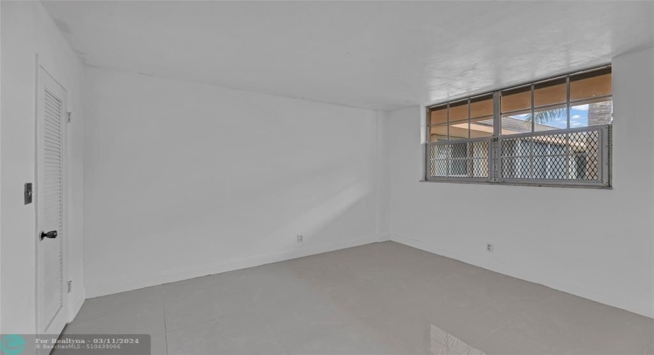 Bedroom #2 with concrete flooring