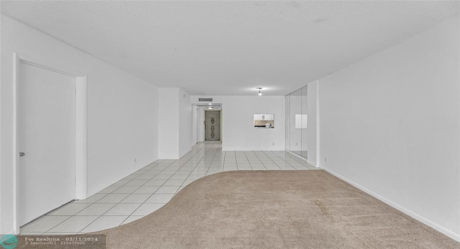 Living room and dining room with window into kitchen
