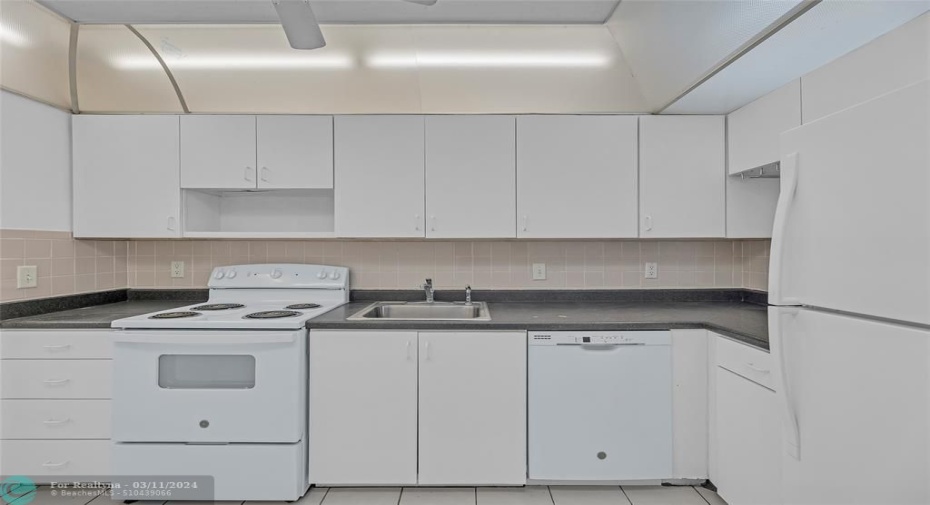 Great spacious kitchen offers a nice clean bright kitchen with white cabinets and appliances