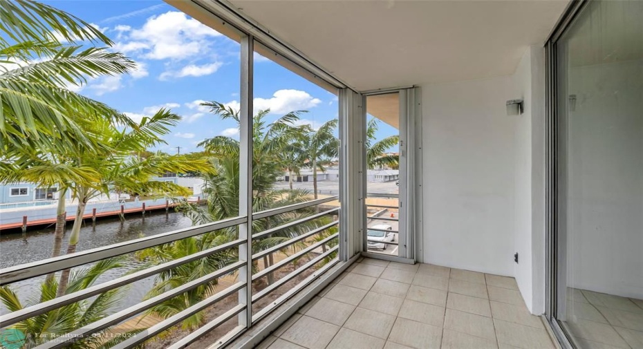 Great screened patio off of the living room offers canal water views