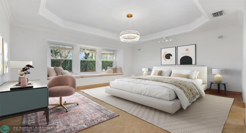 Primary Bedroom with cozy window seating perfect for reading while over looking your fountain garden.