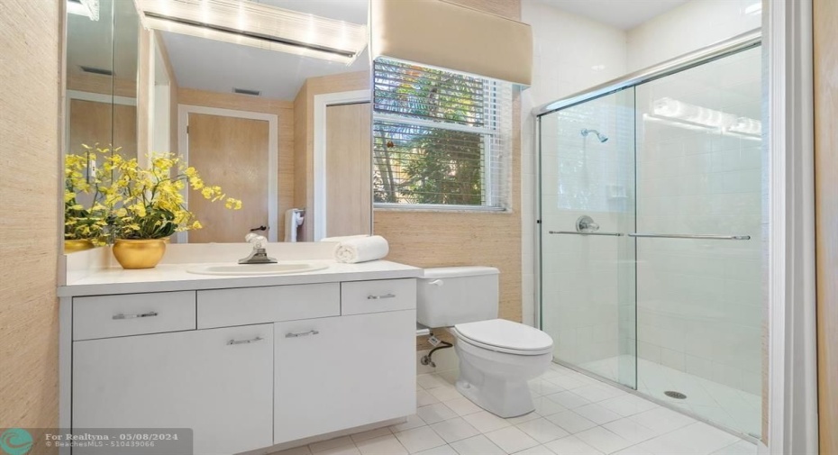 Elegant cabana bath abuts patio with full shower!