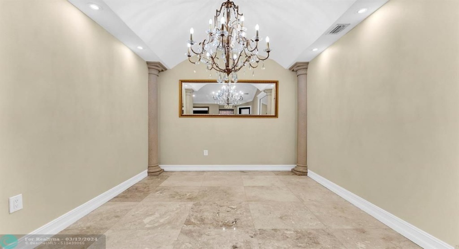 Custom layout w/ expanded dining room, upgraded dining light fixture & roman columns